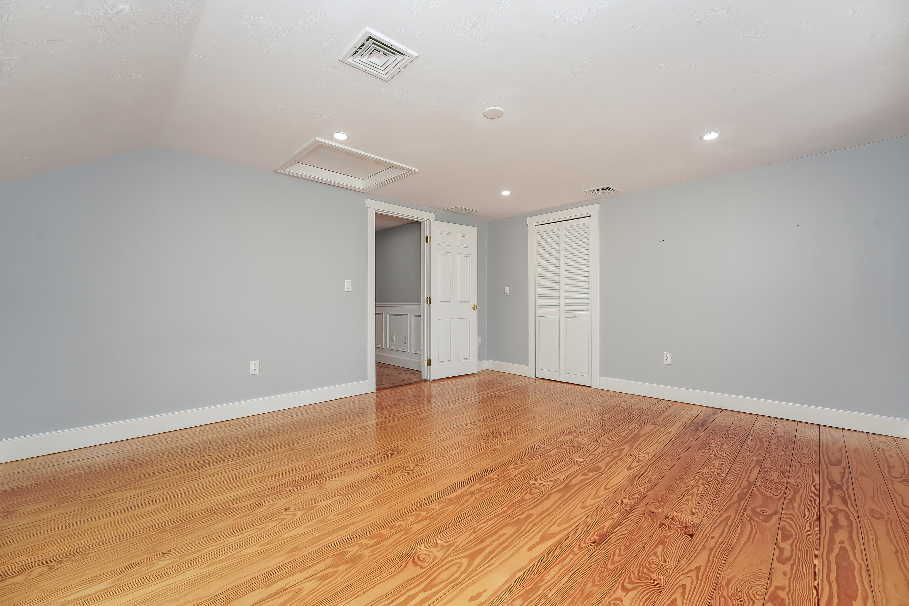 240 Oak Street West Barnstable, MA 02668 - Photo 40 of 89 an empty room with wooden floor and windows