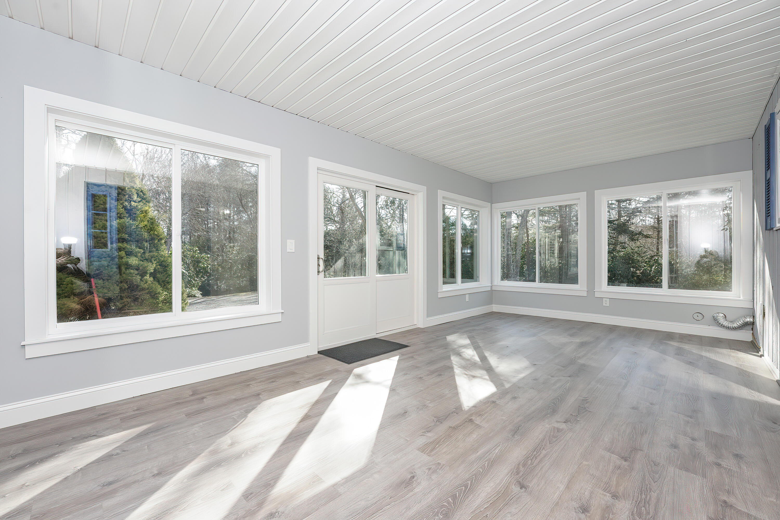 240 Oak Street West Barnstable, MA 02668 - Photo 4 of 89 a view of an empty room with wooden floor and a window