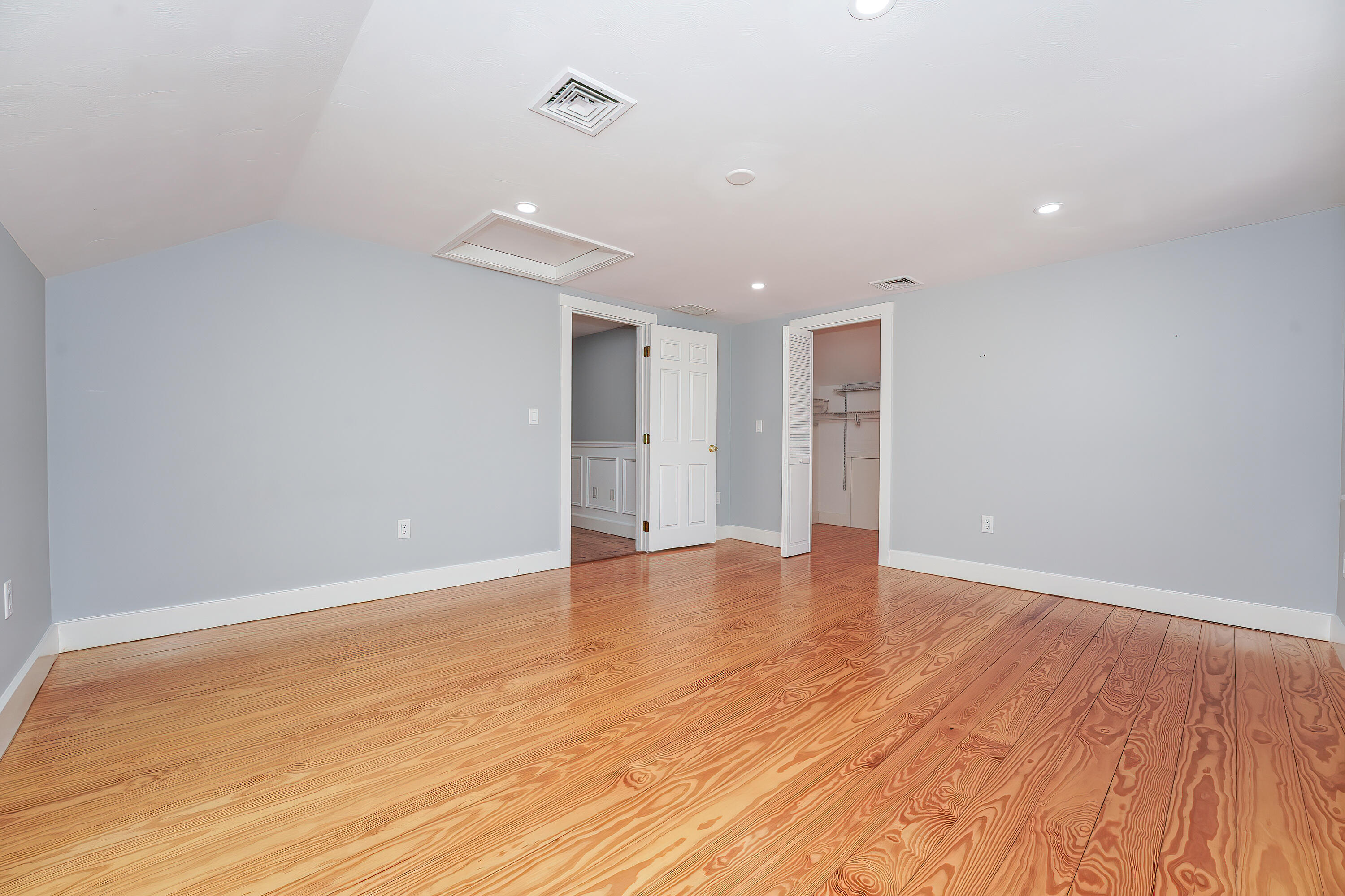 240 Oak Street West Barnstable, MA 02668 - Photo 42 of 89 a view of an empty room with wooden floor and a ceiling fan