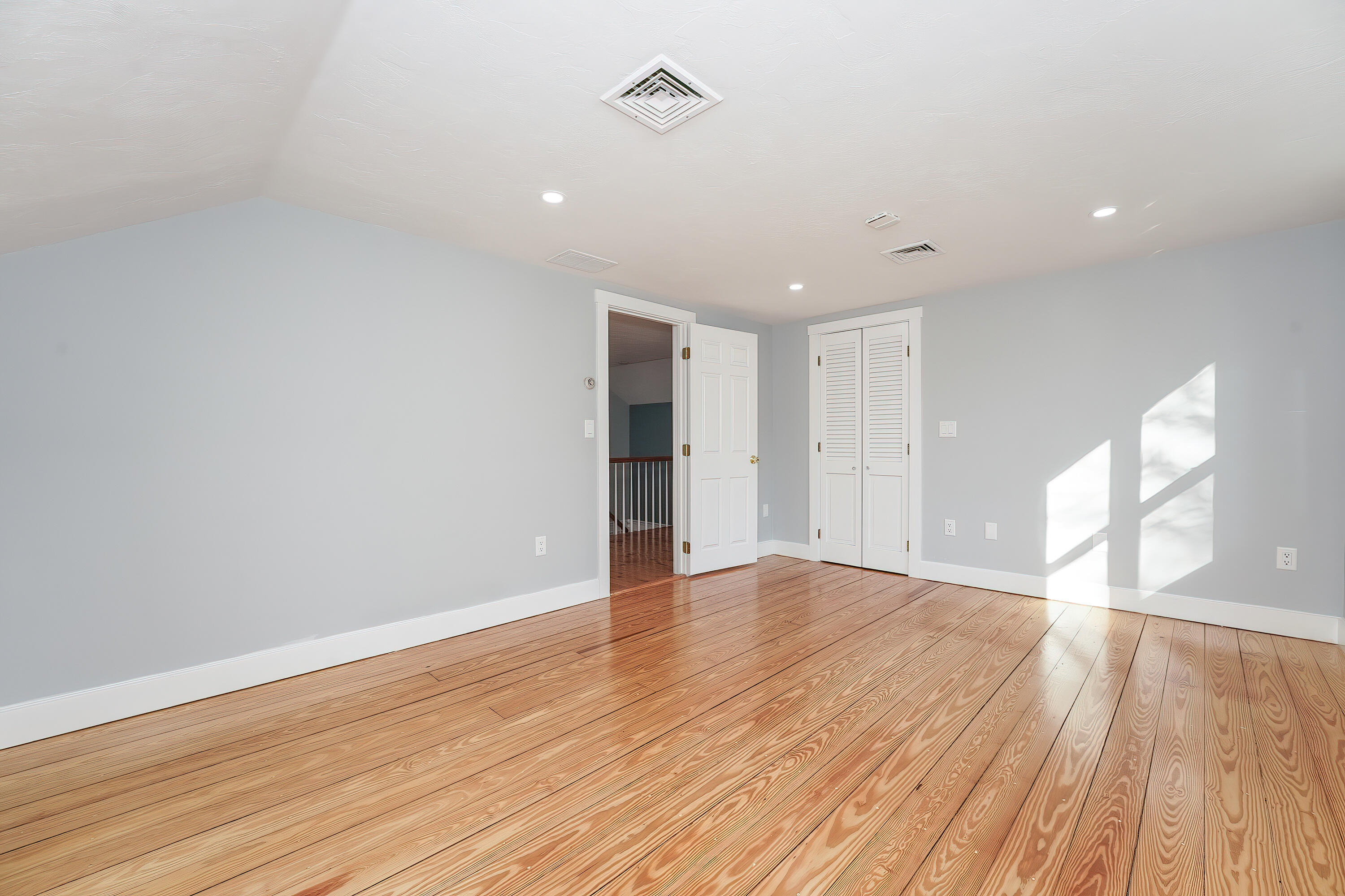 240 Oak Street West Barnstable, MA 02668 - Photo 51 of 89 a view of an empty room with wooden floor and a window