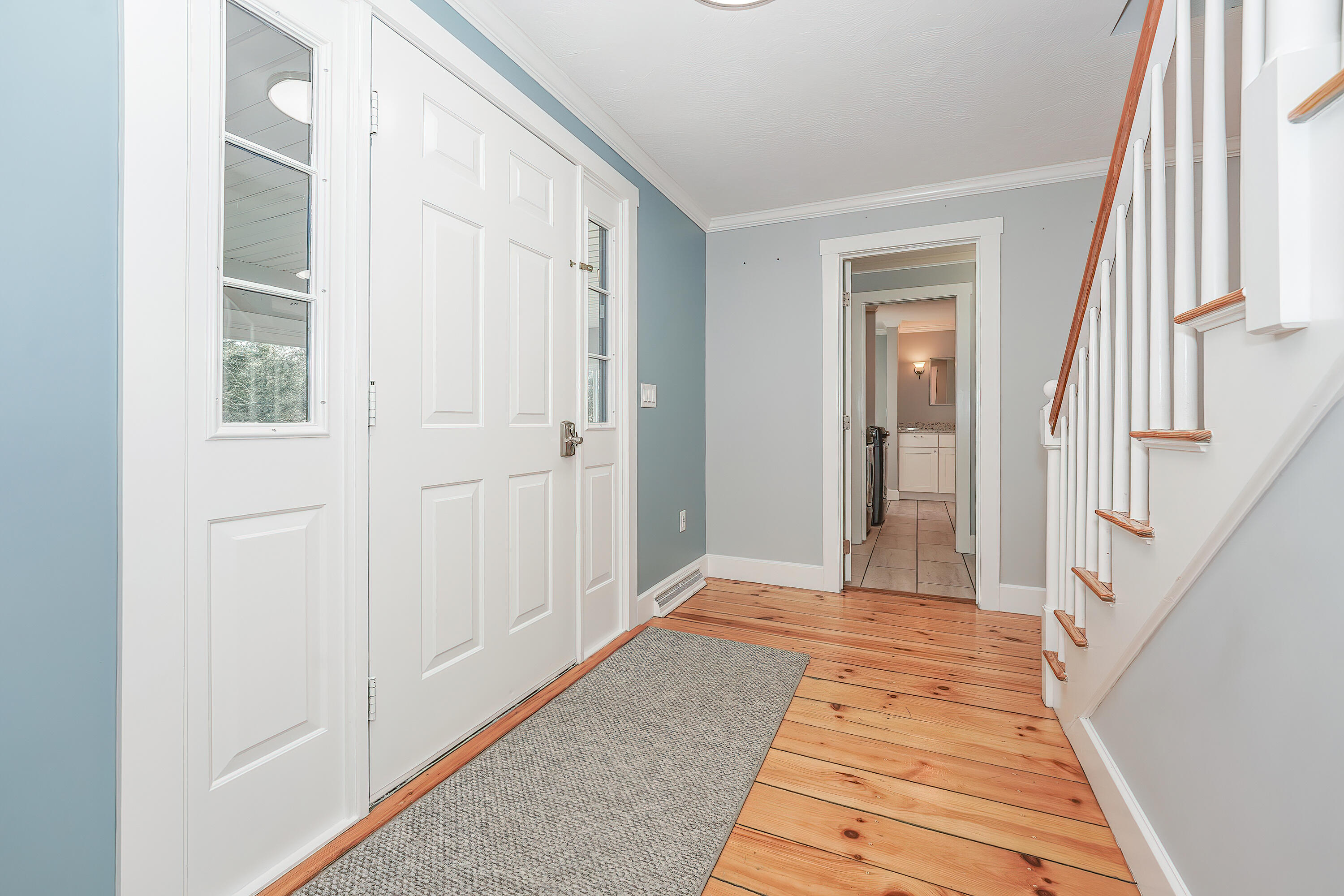 240 Oak Street West Barnstable, MA 02668 - Photo 6 of 89 a view of a hallway with wooden floor and a bathroom