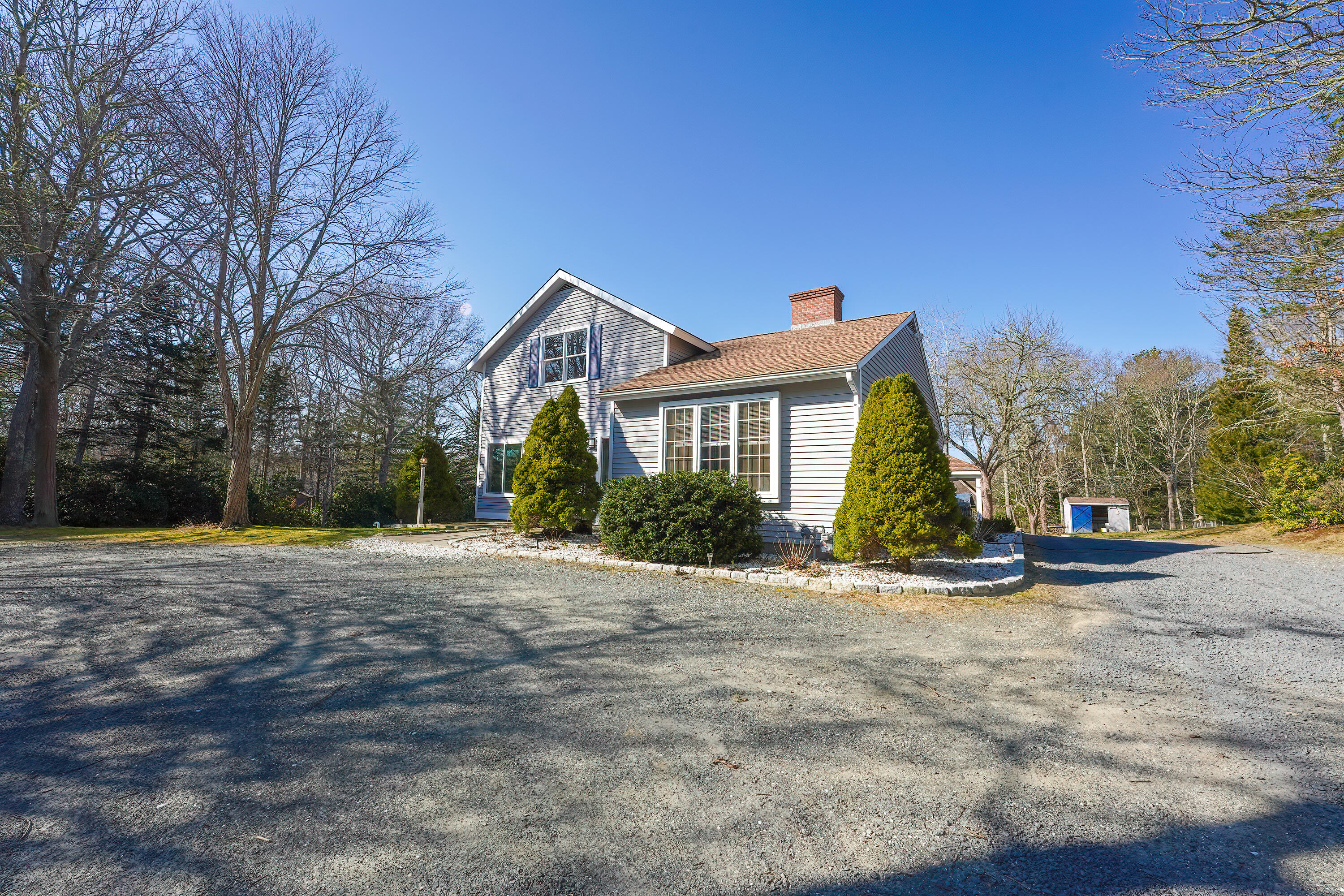 240 Oak Street West Barnstable, MA 02668 - Photo 71 of 89 a front view of a house with a yard and garage