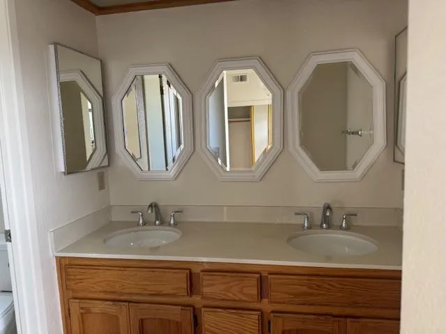 a bathroom with a granite countertop sink a toilet and shower