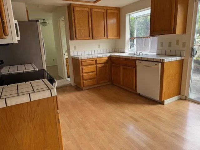 a view of wooden floor and cabinets in a room
