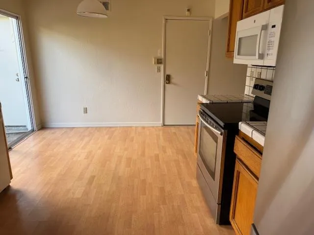 an empty room with windows and fireplace