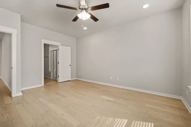 an empty room with chandelier fan