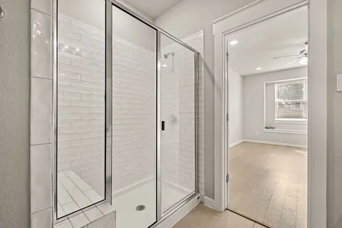 a bathroom with a shower and a glass door