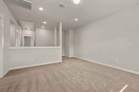 an empty room with windows and pillars in it