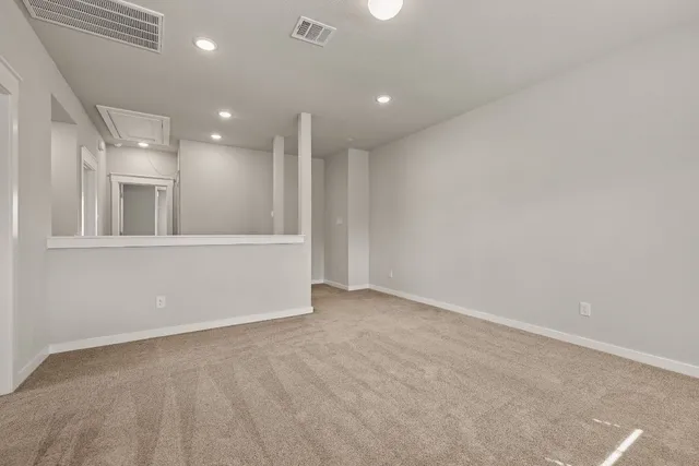 an empty room with windows and pillars in it