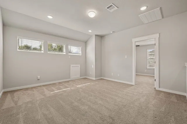 an empty room with windows and closet