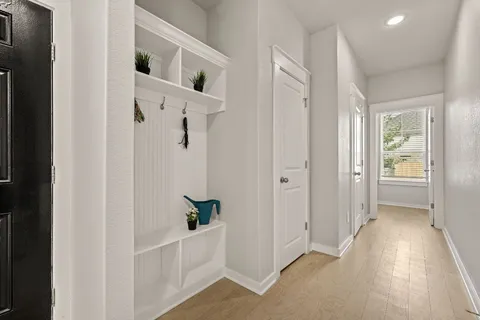 a view of a hallway with closet and wooden floor