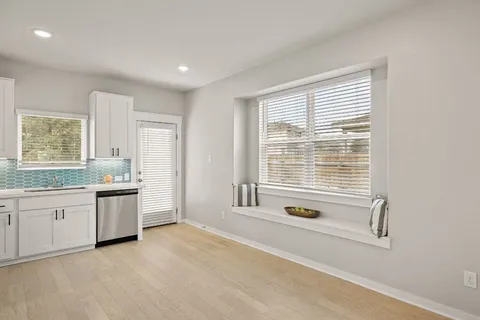 a bathroom with a tub sink and mirror
