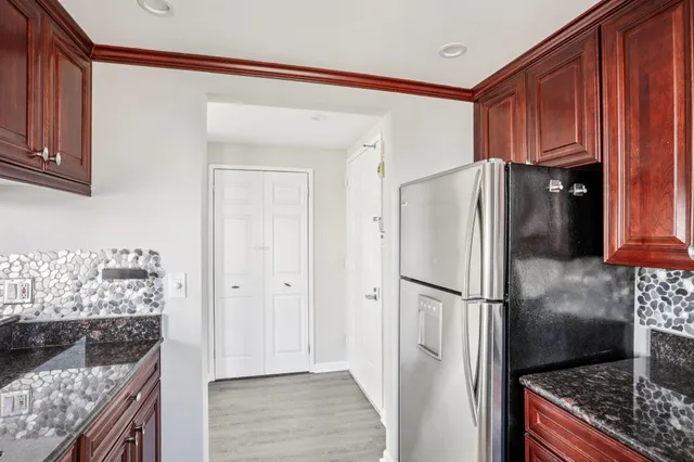 a kitchen with granite countertop a sink and a stove