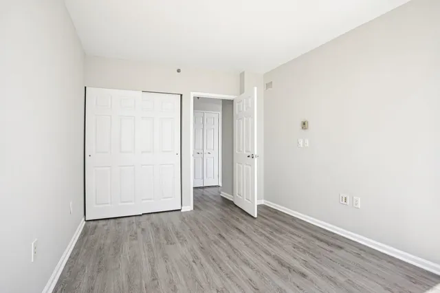 a view of an empty room with wooden floor