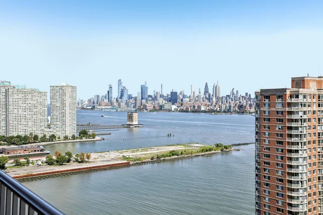 a view of swimming pool with outdoor seating and city view