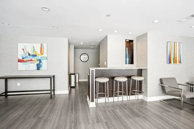 a kitchen with stainless steel appliances granite countertop a refrigerator a stove and a refrigerator