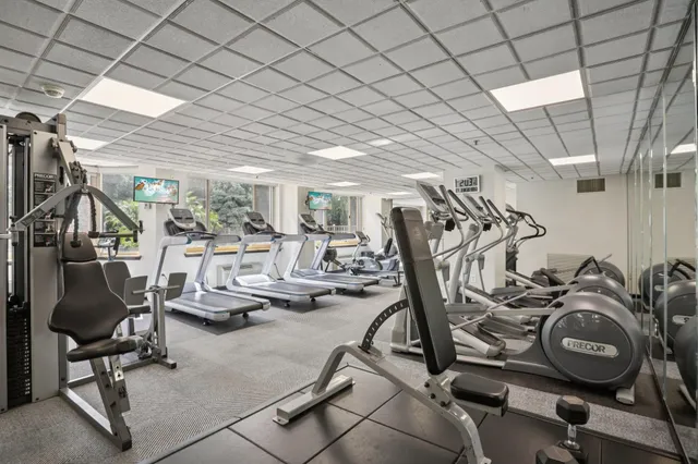 a view of a room with lots of gym equipment