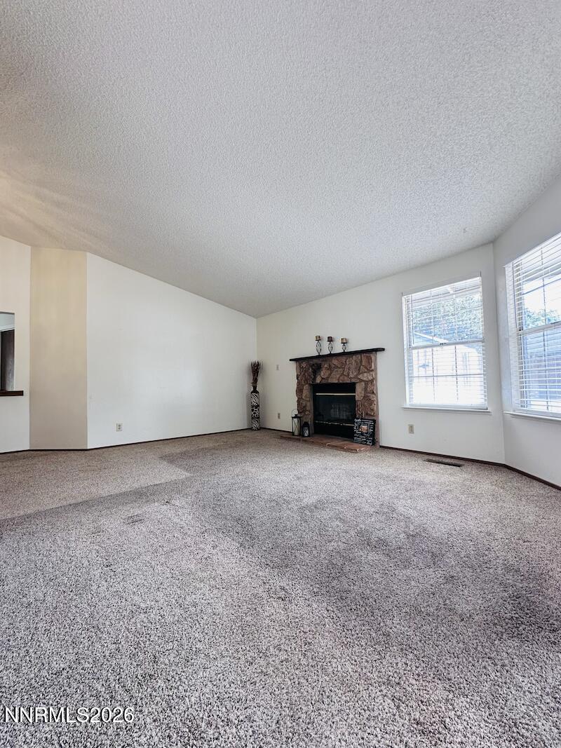1182 Blue Lakes Road Reno, NV 89523 - Photo 5 of 31 an empty room with a fireplace and windows