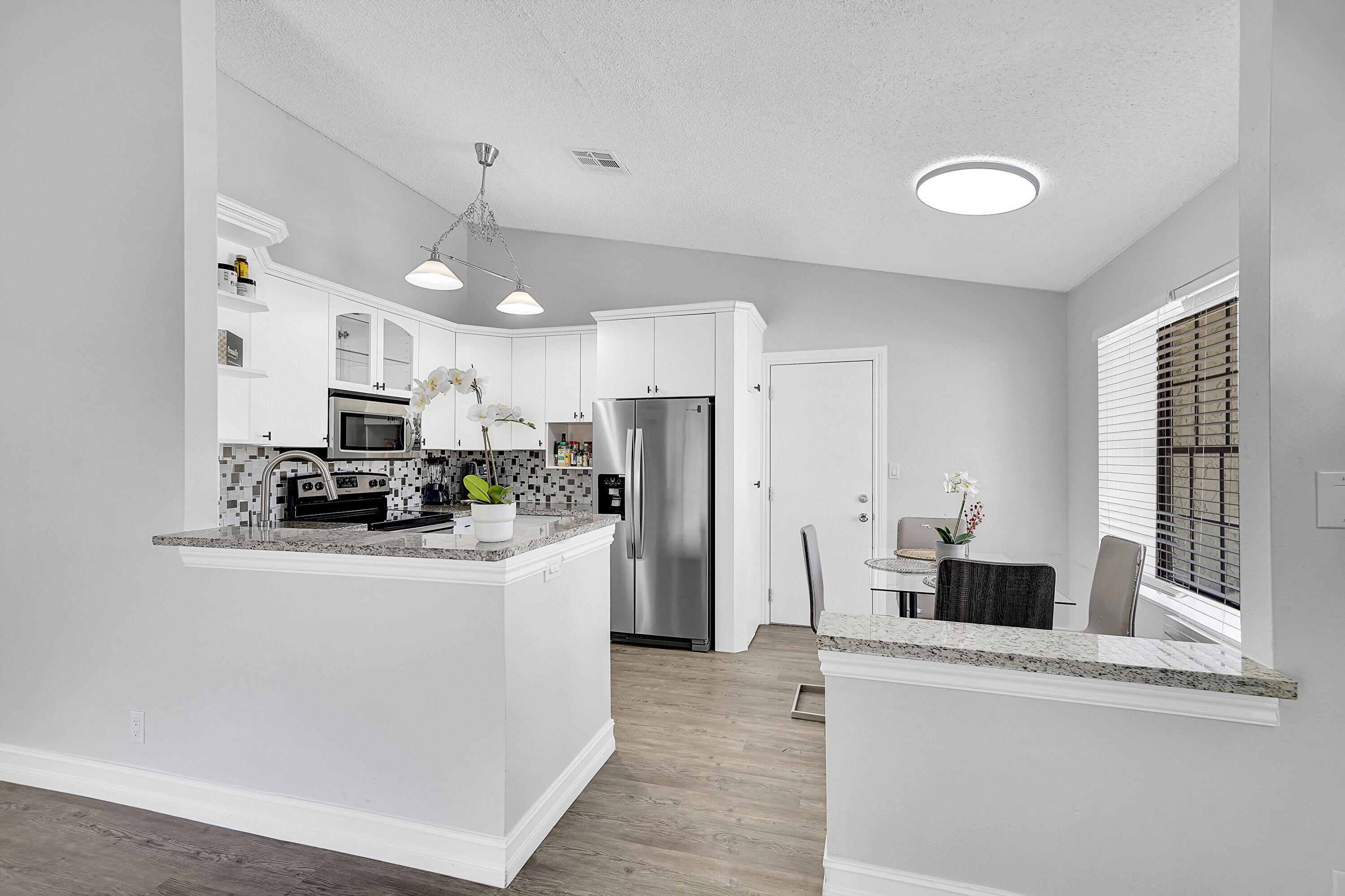 11120 North Terradas Lane Boca Raton, FL 33428 - Photo 14 of 57 a kitchen with stainless steel appliances a refrigerator and a stove top oven