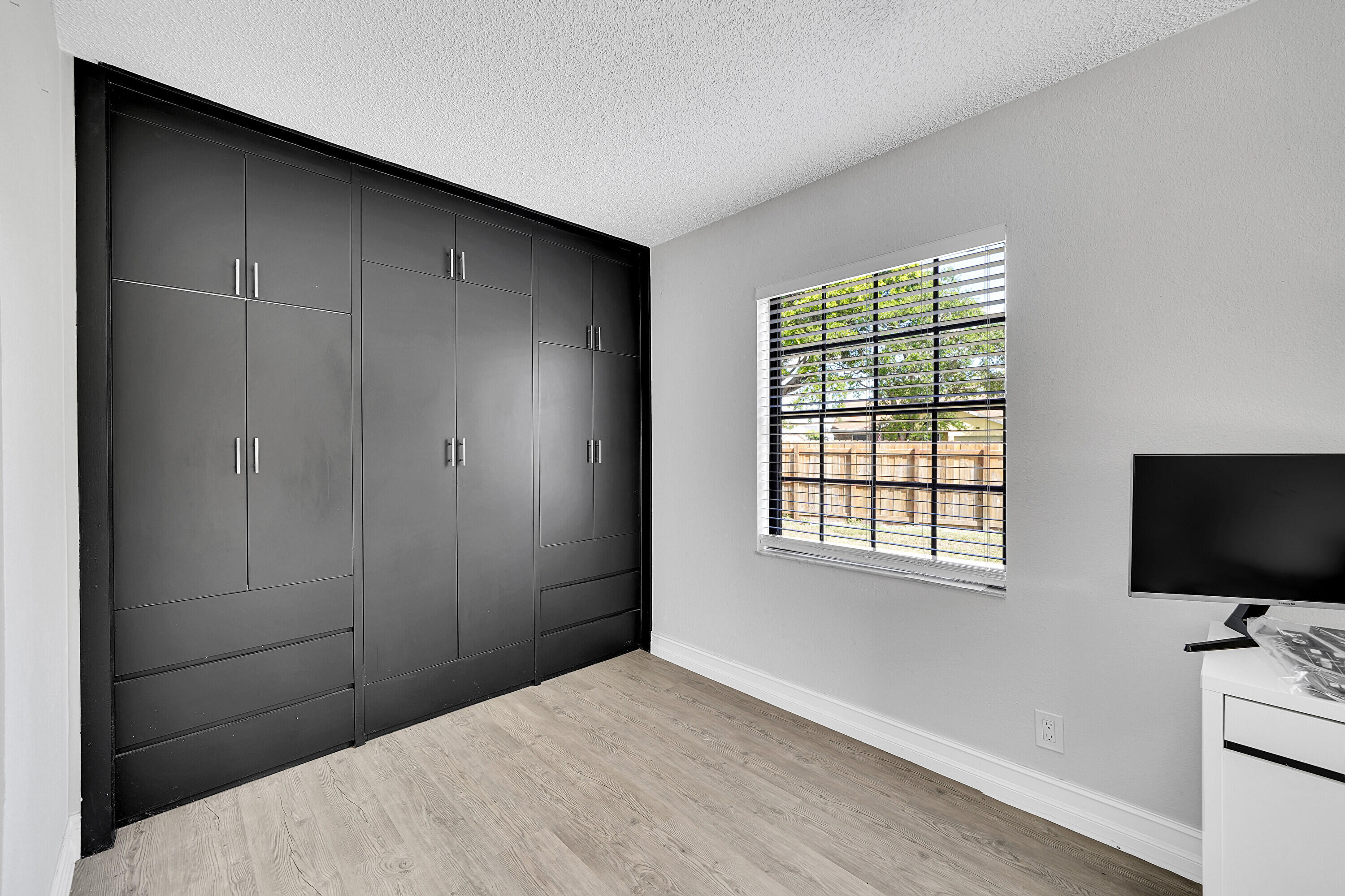 11120 North Terradas Lane Boca Raton, FL 33428 - Photo 24 of 57 a bedroom with a bed and a flat screen tv