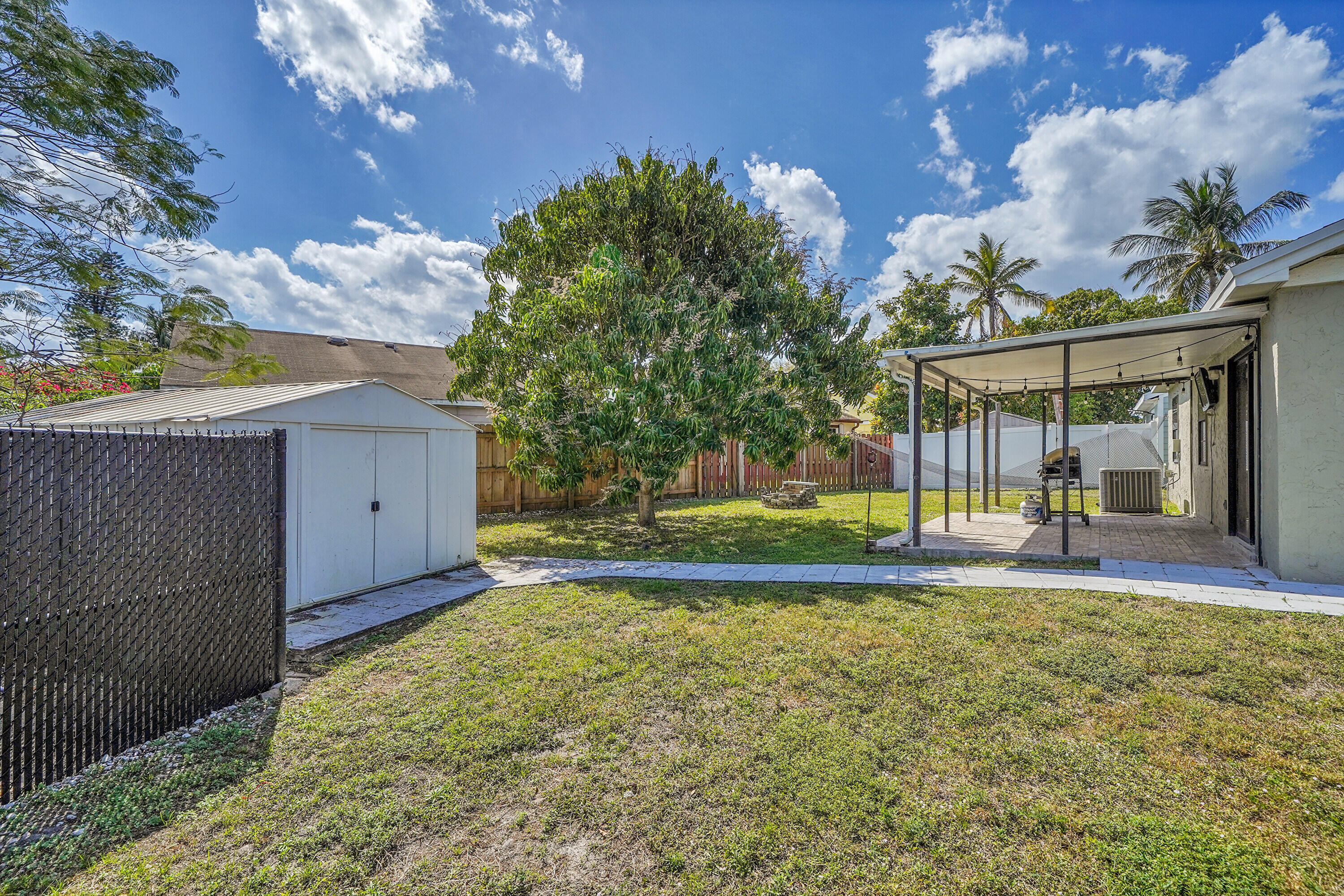 11120 North Terradas Lane Boca Raton, FL 33428 - Photo 36 of 57 a view of a house with a big yard and large tree