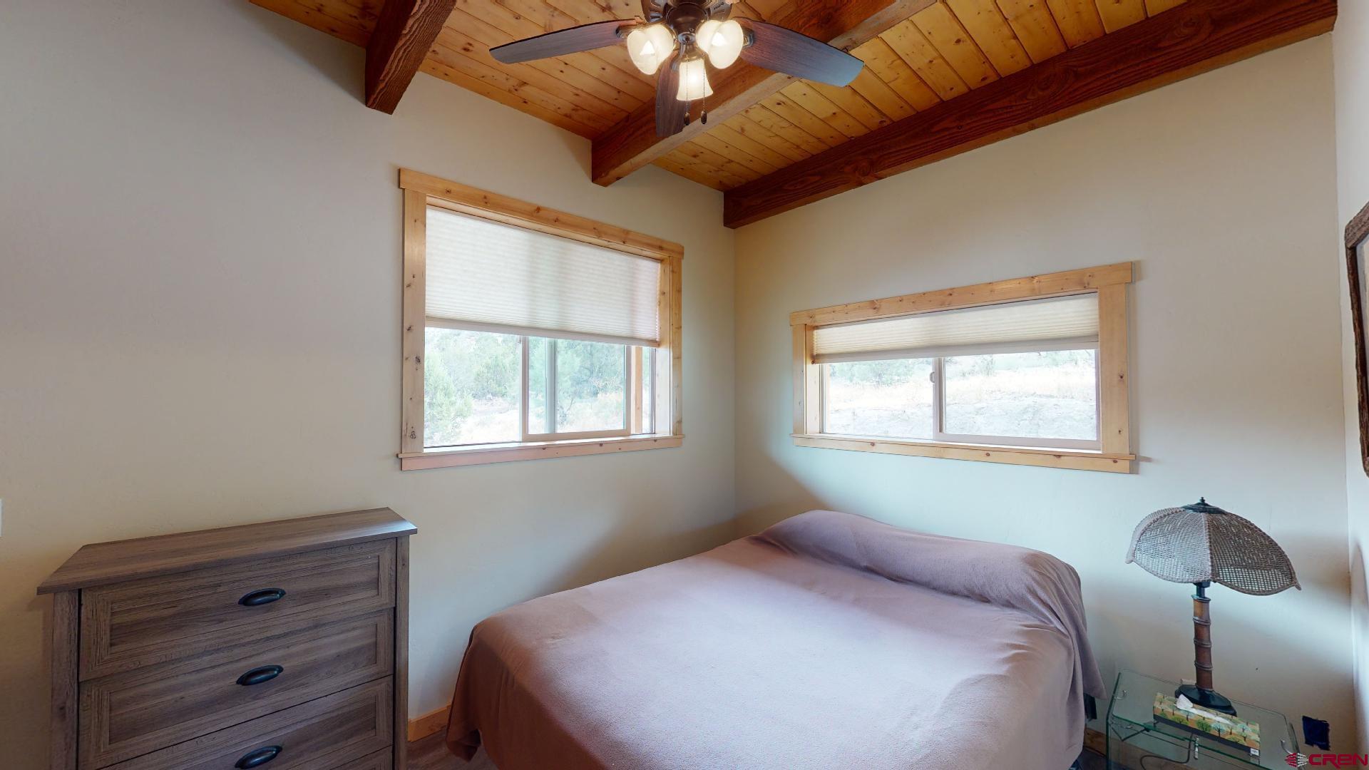 16800 Grange Road Paonia, CO 81428 - Photo 14 of 37 a bedroom with a bed and a chandelier