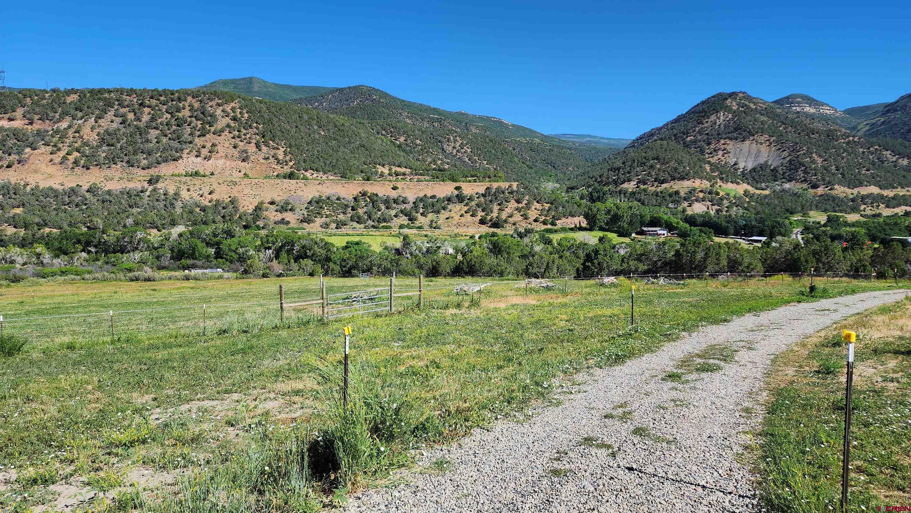 16800 Grange Road Paonia, CO 81428 - Photo 26 of 37 a view of a lush green hillside and a houses