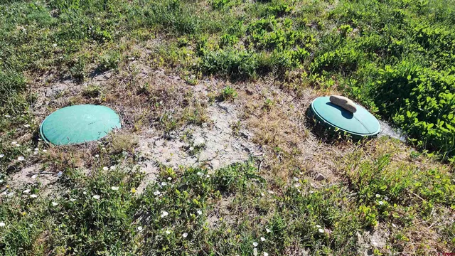 a backyard of a house with a yard and outdoor seating
