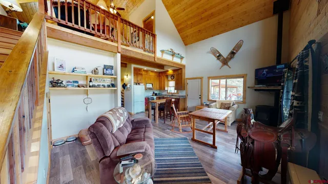a living room with furniture a fireplace and a large window
