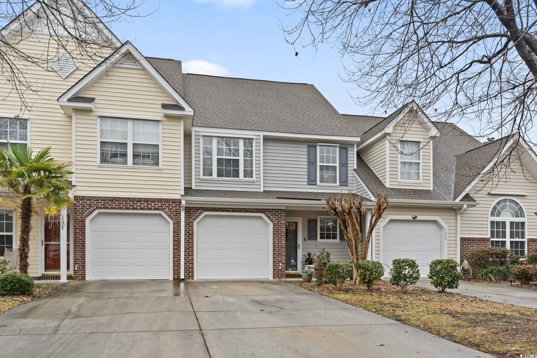 1024 Stanton PI, Unit 1024 Myrtle Beach, SC 29579 - Photo 1 of 26 View of front of home with brick siding, roof with shingles, concrete driveway, and an attached garage