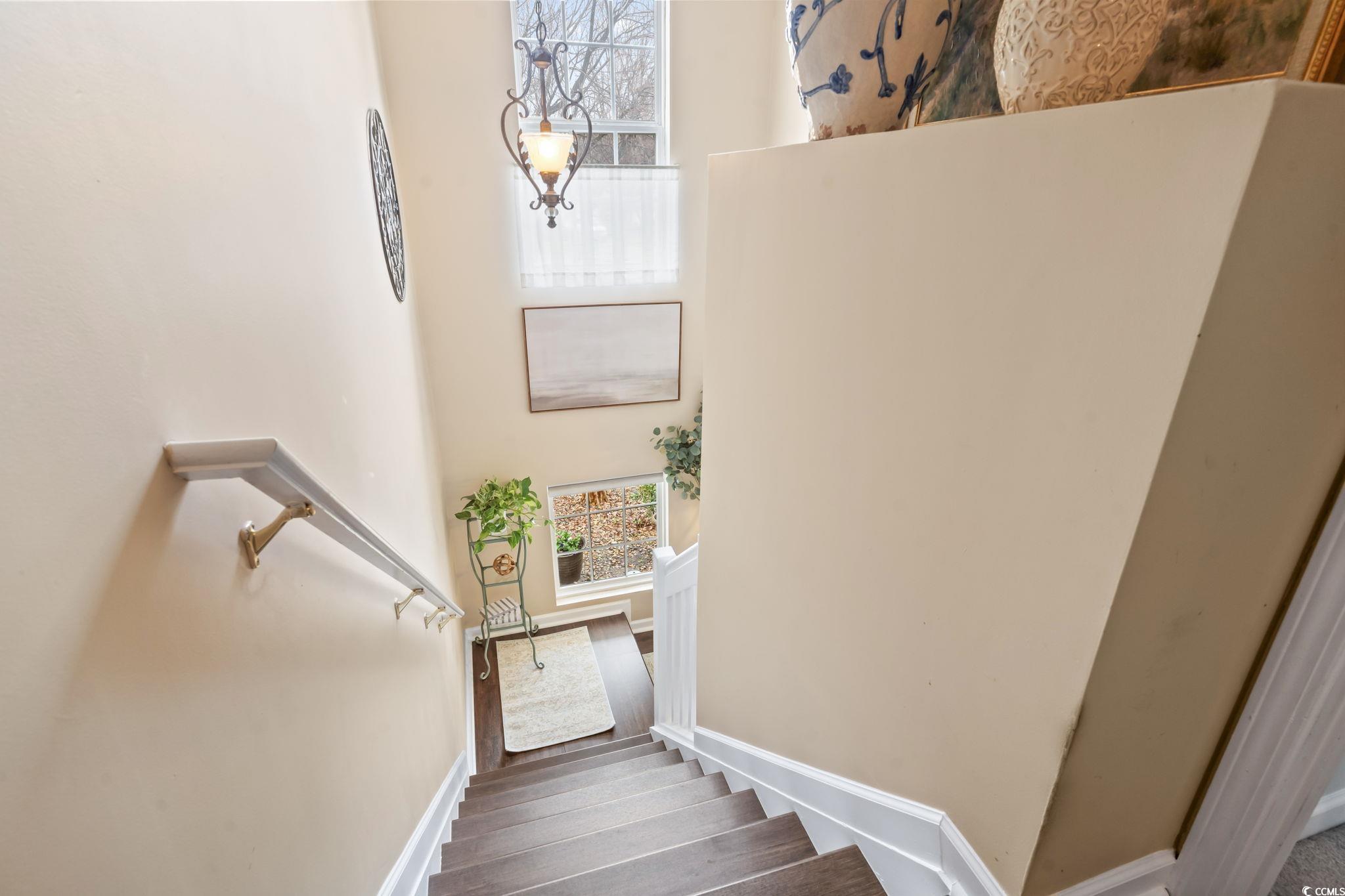 1024 Stanton PI, Unit 1024 Myrtle Beach, SC 29579 - Photo 12 of 26 Staircase featuring a high ceiling, wood finished floors, and baseboards
