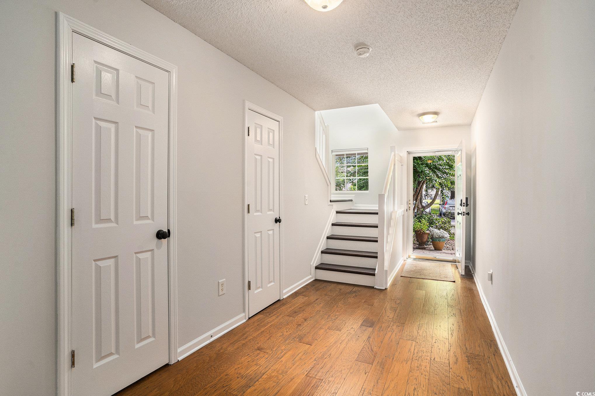 1024 Stanton PI, Unit 1024 Myrtle Beach, SC 29579 - Photo 2 of 26 Corridor featuring a textured ceiling and wood finished floors