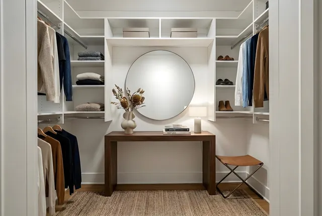 a living room with a mirror and a wooden floor