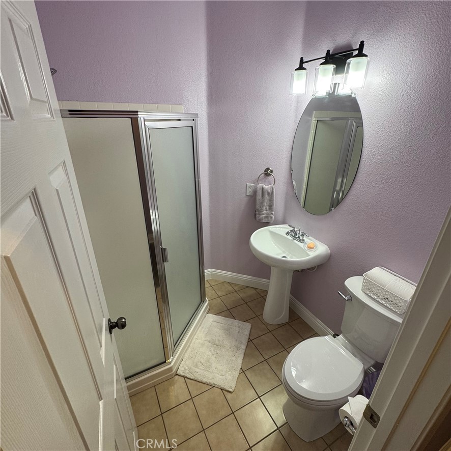 44528 Camolin Lane Lancaster, CA 93534 - Photo 25 of 75 a bathroom with a toilet a sink and a mirror