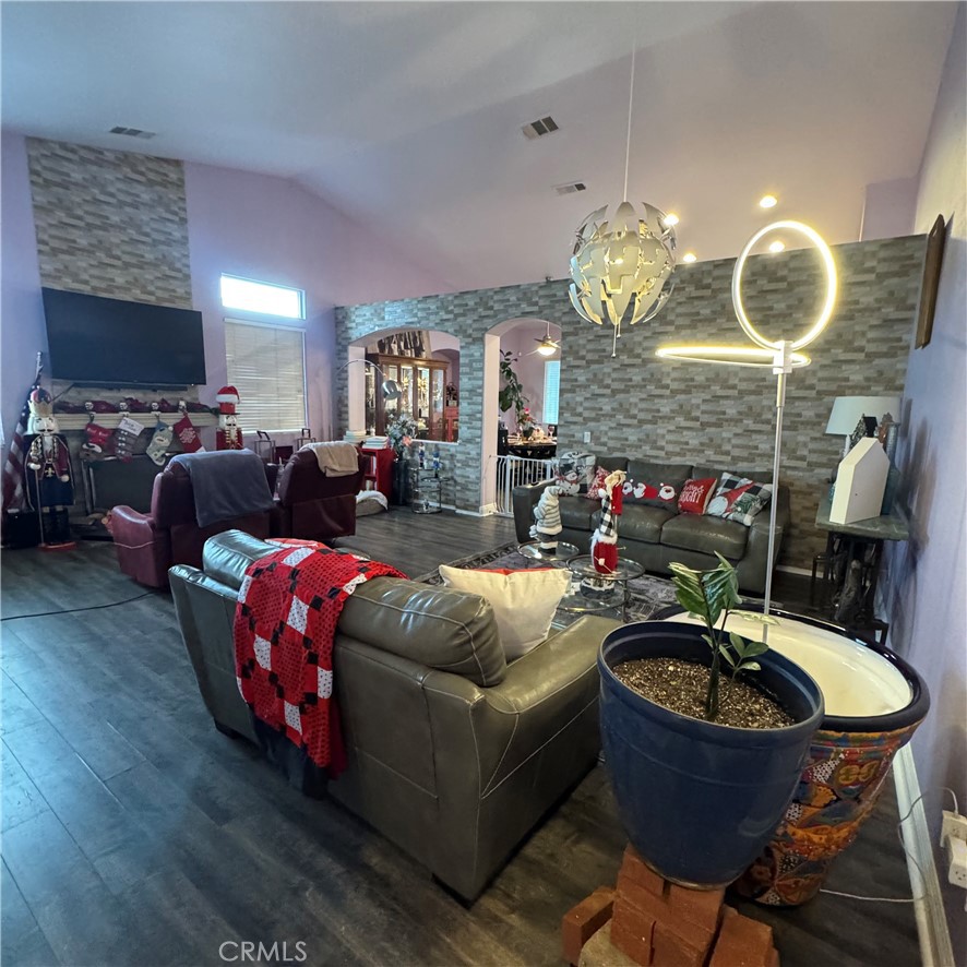 44528 Camolin Lane Lancaster, CA 93534 - Photo 29 of 75 a living room with fireplace furniture and a chandelier