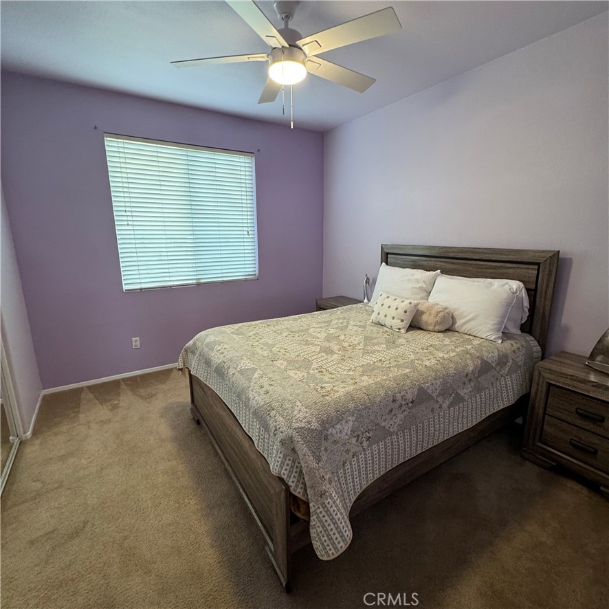 44528 Camolin Lane Lancaster, CA 93534 - Photo 36 of 75 a bedroom with a bed and a chandelier