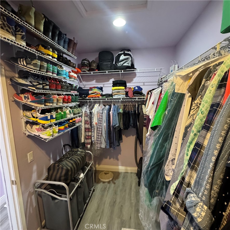 44528 Camolin Lane Lancaster, CA 93534 - Photo 53 of 75 a view of walk in closet with clothes and shoes