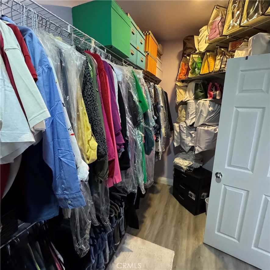 44528 Camolin Lane Lancaster, CA 93534 - Photo 54 of 75 a view of walk in closet with clothes and shoes