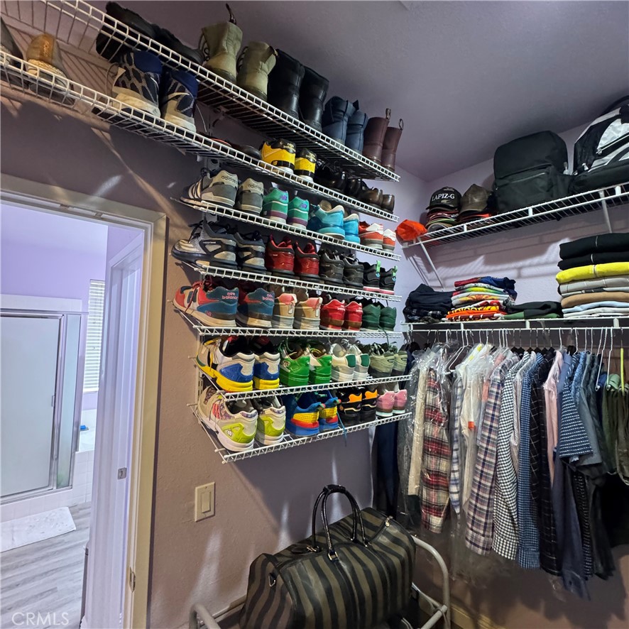 44528 Camolin Lane Lancaster, CA 93534 - Photo 56 of 75 a view of walk in closet with clothes and shoes