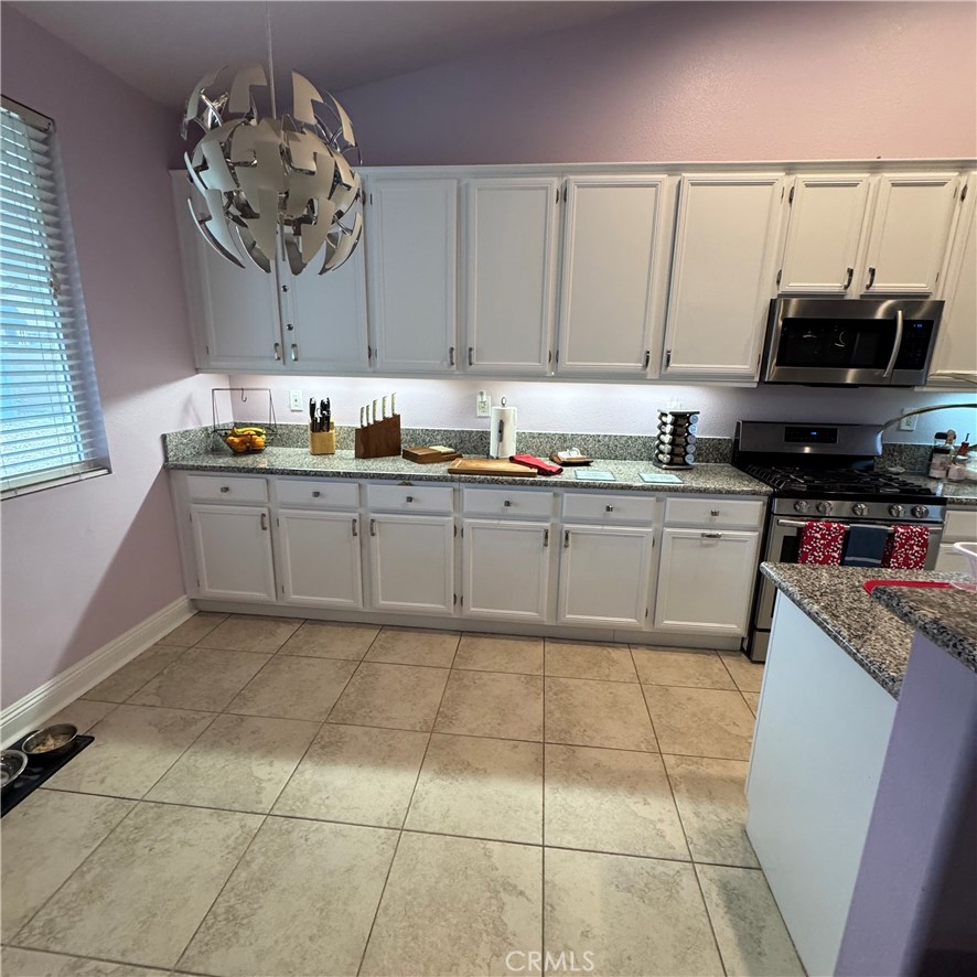 44528 Camolin Lane Lancaster, CA 93534 - Photo 66 of 75 a kitchen with stainless steel appliances granite countertop a sink and cabinets