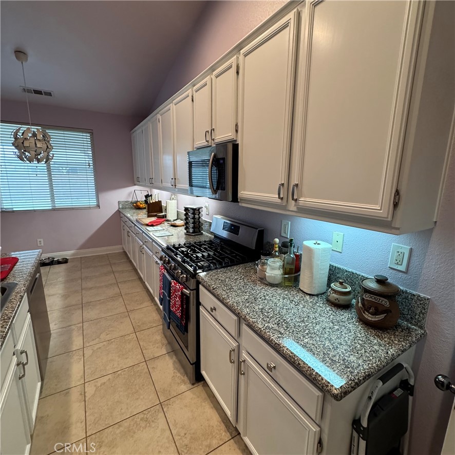 44528 Camolin Lane Lancaster, CA 93534 - Photo 72 of 75 a kitchen with stainless steel appliances granite countertop a sink stove and cabinets