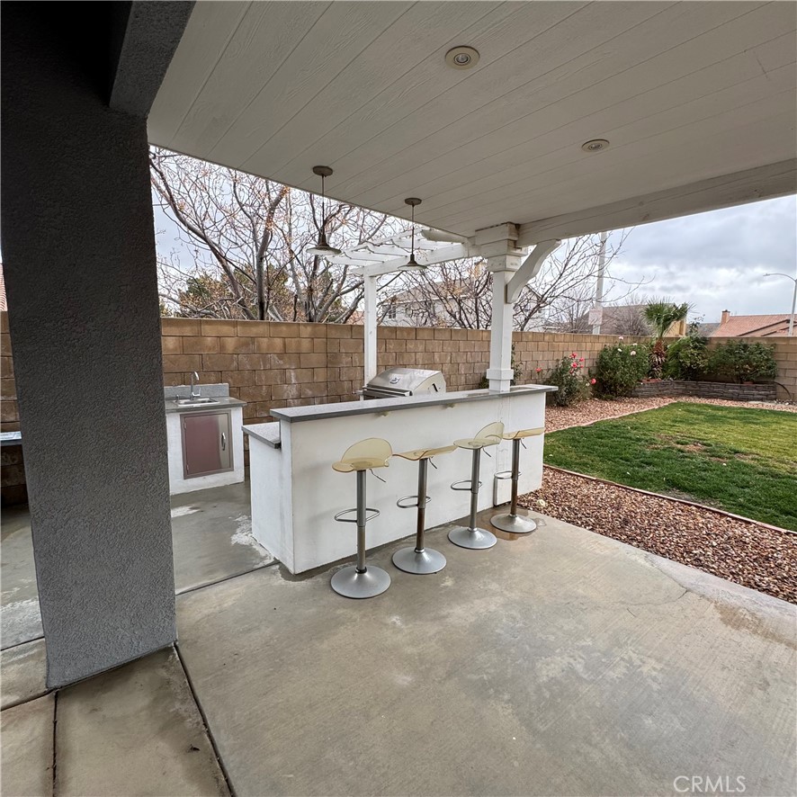 44528 Camolin Lane Lancaster, CA 93534 - Photo 74 of 75 a view of a porch with furniture and garden