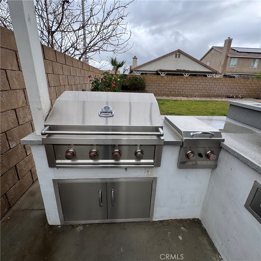 44528 Camolin Lane Lancaster, CA 93534 - Photo 10 of 75 a stove top oven sitting inside of a kitchen