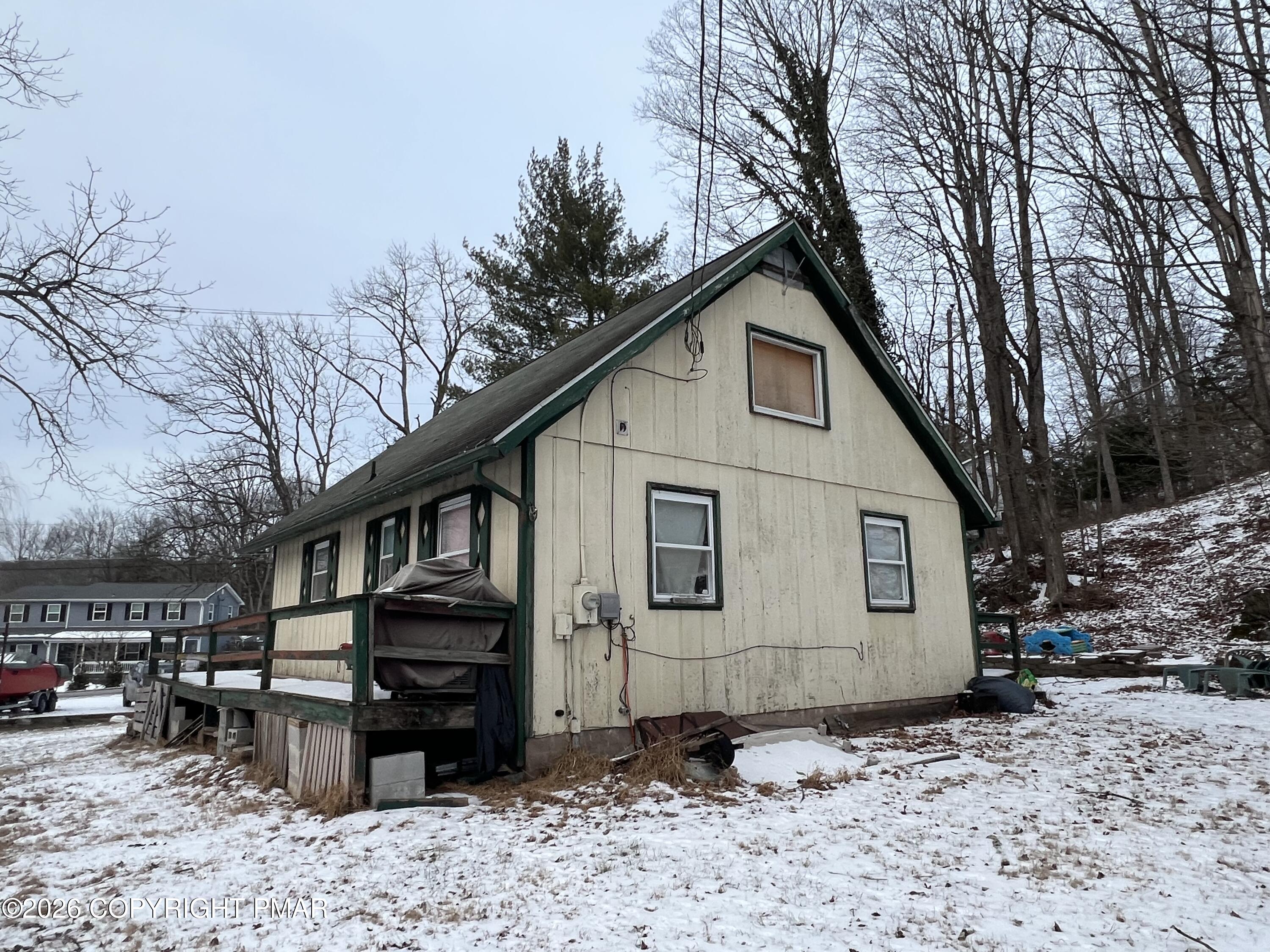 5062 Pine Ridge Road North East Stroudsburg, PA 18302 - Photo 16 of 17 a view of a house with a yard covered in snow