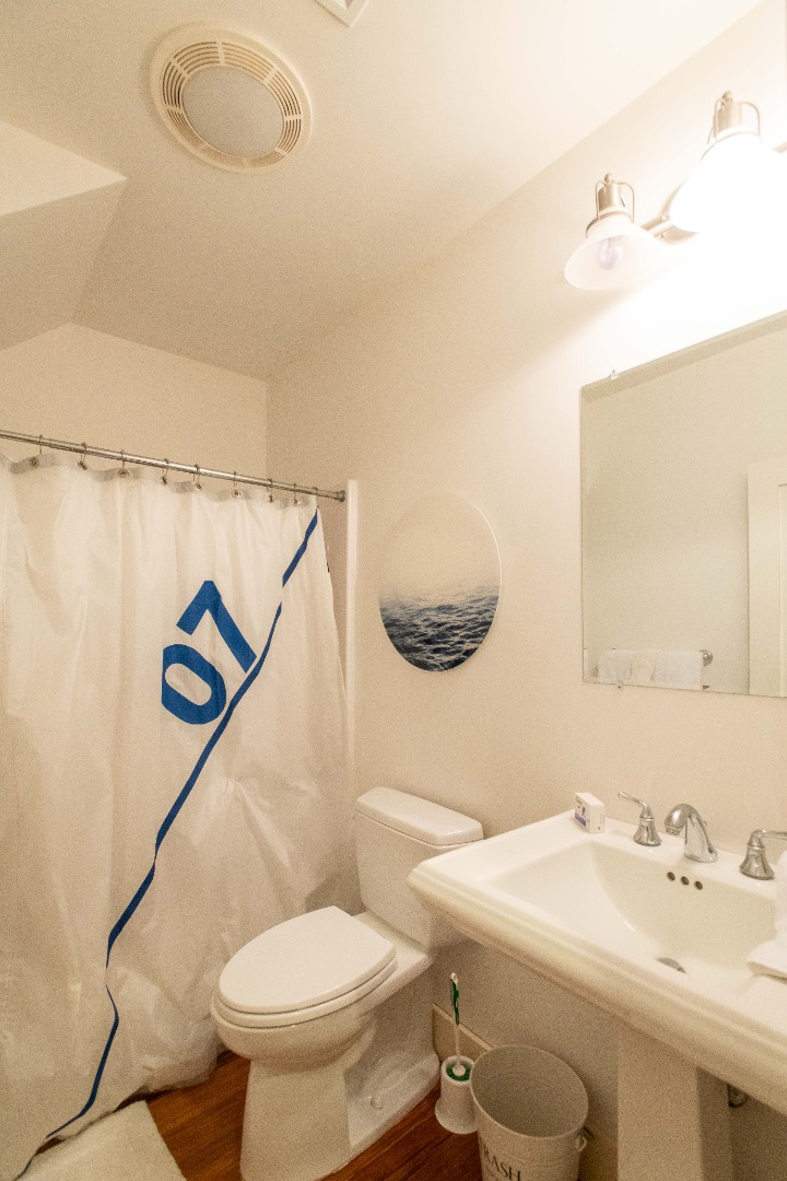 146 Surfside Road Nantucket, MA 02554 - Photo 34 of 43 a bathroom with a sink mirror vanity and toilet