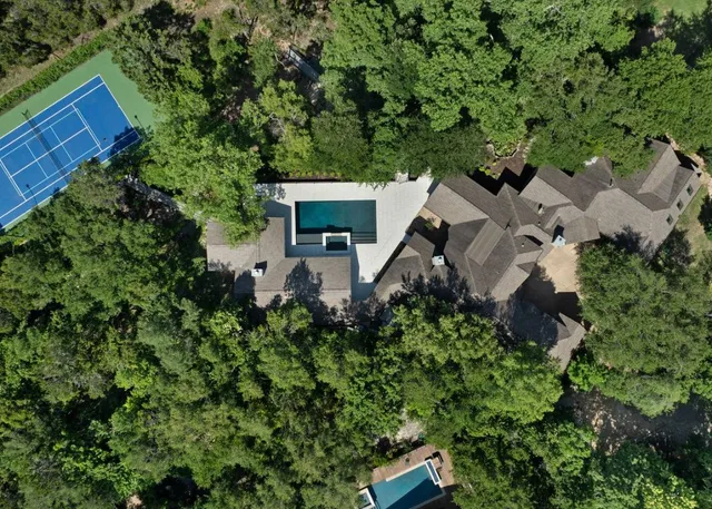 an aerial view of a house with a yard