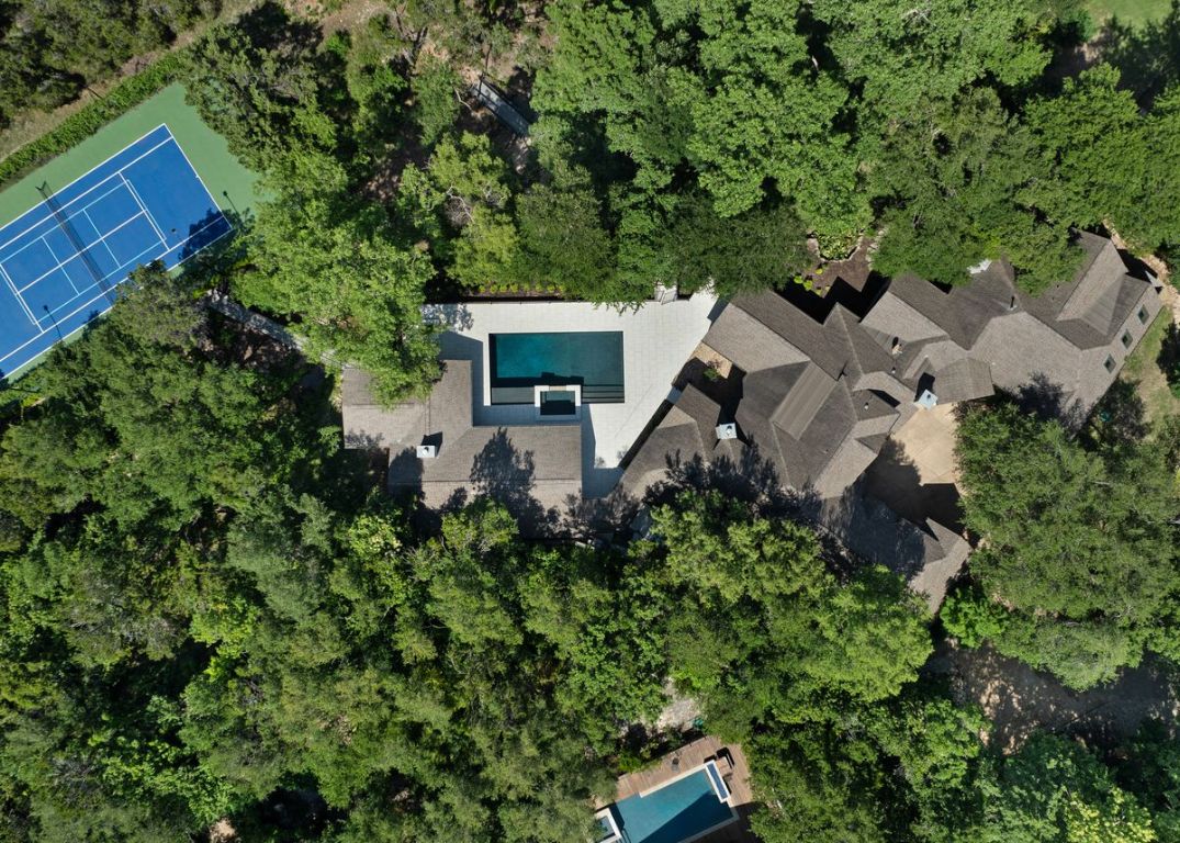 an aerial view of a house with a yard