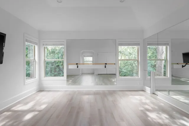 a view of a livingroom with wooden floor and a flat screen tv