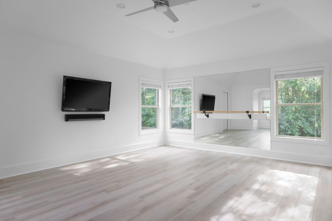 506 Konstanty Circle Austin, TX 78746 - Photo 12 of 23 a view of a livingroom with wooden floor and a flat screen tv