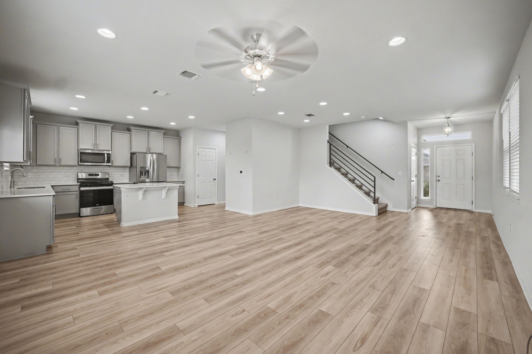 10807 Sentinel Drive Austin, TX 78747 - Photo 3 of 16 Unfurnished living room featuring a ceiling fan, light wood-style floors, and recessed lighting